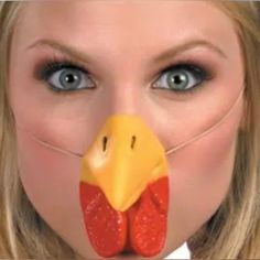 a woman with a fake chicken's head on her face