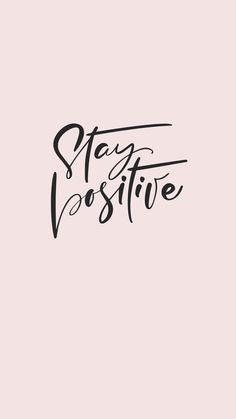 the words stay positive are written in black ink on a pink background with an arrow