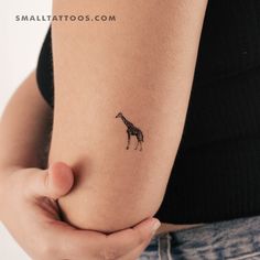 a small giraffe tattoo on the right side of the stomach is shown in black ink