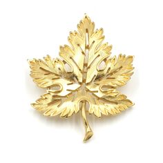 "Vintage Trifari gold toned maple leaf brooch. The petals have a brushed gold finish and the stem and leaves have a smooth finish giving this piece beautiful dimension. Nice large statement for a lapel. A classic statement. Marked \"Trifari TM\". Clasp is in good working order.  The gold finish is in good condition. Measures: 2.19\" Tall x 1.7\" Wide Weighs: 16.9 grams Please feel free to contact me with questions and/or for additional photos. More vintage Trifari in the shop: Trifari forget me not brooch - www.etsy.com/BaseFare/listing/1419046682 Brushed gold bangle - www.etsy.com/BaseFare/listing/1279578552 *Free Domestic Shipping on Orders Over $35* All orders ship USPS First Class. If you would like to add insurance please reach out before purchase. All of our items are in good, vintag Trifari Brooch, Vintage Trifari, Leaf Brooch, Brooch Vintage, Maple Leafs, Past Life, Lapel Pin, Gold Bangles, Maple Leaf