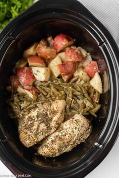 chicken, potatoes and green beans in the crock pot with parsley on top