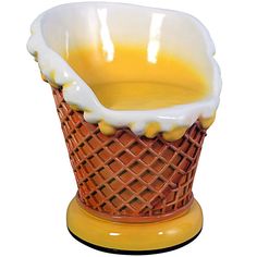 a yellow and white ice cream dish on a stand