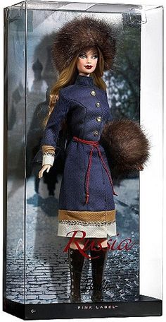 a barbie doll in a glass case with fur on her head and coat over her shoulders