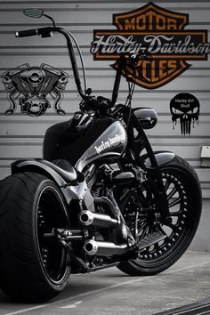 a motorcycle parked in front of a garage door with the words harley davidson on it