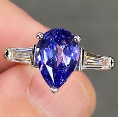 a blue and white diamond ring with baguets