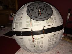 a paper mache ball sitting on top of a table