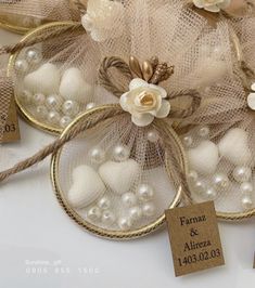 wedding favors are wrapped in burlap and adorned with white flowers, pearls and twine