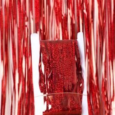 red streamers are hanging from the ceiling in front of a white chair and table