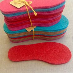 a pile of felt covered with red and blue colors sitting on top of a table