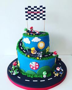 a birthday cake with cars and race flags on top