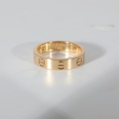 This is part of Chairish’s Fine Jewelry assortment.  Cartier Love Diamond Wedding Band With 1 Diamond in 18K Yellow Gold 0.02 CTW  PRIMARY DETAILS  SKU: 132486  Listing Title: Cartier Love Diamond Wedding Band With 1 Diamond in 18K Yellow Gold 0.02 CTW  Condition Description: Cartier's Love collection is the epitome of iconic, from the recognizable designs to the history behind the line-up. The collection started in 1969 with the bangle bracelet, which is engraved with a circular motif throughou Vintage Cartier Diamond Jewelry, Cartier Classic Ring With Polished Finish, Formal Cartier Ring Stamped 14k, Classic Cartier Round Cut Diamond Ring, Cartier 14k Stamped Formal Rings, Cartier 14k Stamped Jewelry For Anniversary, Cartier 14k Stamped Rings For Formal Occasions, Timeless Polished Cartier Rings, Cartier Oval Rings Fine Jewelry