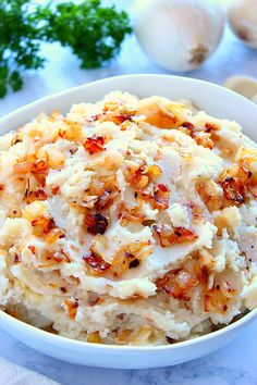 mashed potatoes with bacon and parsley in a white bowl