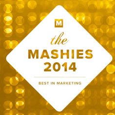 the mashies logo on top of a gold background with lights in the background