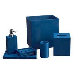 a blue bathroom set with soap dispenser, toothbrush holder and tissue dispenser