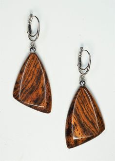 The earrings are one of a kind and handmade from Black Palm wood and have very smooth and brilliant cut  surface. Lever backs are Rhodium plated. Care instructions: Avoid direct contact with perfumes, alcohol, water and other solvents that may damage wood finish. Wipe jewelry with soft dry cloth. Handmade Natural Wood Teardrop Jewelry, Handmade Wood Drop Earrings, Brown Wooden Dangle Jewelry, Brown Wood Drop Earrings, Unique Brown Wooden Earrings, Palm Wood, Wood Earrings, Rhodium Plated, Jewelry Earrings Dangle