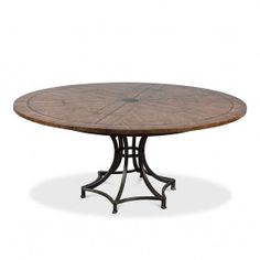 an oval dining table with wrought iron base and wood top, viewed from the front