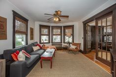 a living room filled with furniture and lots of windows