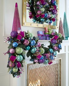 a christmas wreath is hanging on the mantle next to a fire place with presents in it