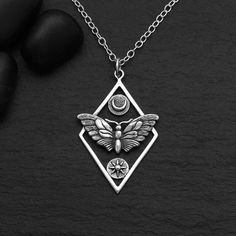 Geometric Moth Charm with Sun and Moon Necklace is made of .925 sterling silver.  Stamped 925.   Your choice 16", 18", 20". 22", 24" Size Pendant: 35x21mm - Length measurement includes the 5 mm soldered jump ring. S6152 -SV-CHRM Channel the allure of the moth when you wear this sterling silver geometric moth charm necklace with sun and moon. The diamond shape is not only a beautiful way to frame the moth and inset the sun & moon disks, but it also provides spaces for you to attach more charms an Nickel-free Sterling Silver Butterfly Necklace, Bohemian Butterfly Sterling Silver Necklace, Bohemian Sterling Silver Butterfly Necklace, Geometric Moth, Moth Necklace, Sun And Moon Necklace, The Moth, Length Measurement, Winter Jewelry