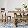 a wooden table with two chairs and a rug on the floor in front of it