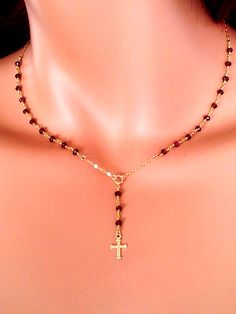 "This is a petite rosary inspired necklace made of 2.5mm faceted garnet gemstones. This dainty necklace has a 14kt gold filled cable chain and comes in a 16\", 18\", 20\" or 22\". Priced accordingly, you choose size. A small, delicate 14kt gold filled cross pendant measures 1/2\" and hangs from drop. Total drop measures 1 1/2\" with cross. Spring clasp sits at back. This necklace also comes in other gemstones: Iolite, black spinel, amethyst or pyrite (see last picture). May be ordered in 925 Ste Crucifix Jewelry With Faceted Beads As Gift, Crucifix Jewelry With Faceted Beads For Gift, Crucifix Shaped Jewelry With Faceted Beads As Gift, Rosary Inspired Necklace, Gold Rosary Necklace, 14kt Gold Jewelry, Estilo Kardashian, Gold Rosary, Beautiful Beaded Bracelet