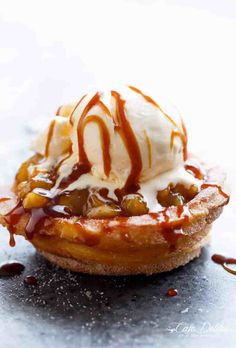 a waffle topped with ice cream and caramel drizzled on top