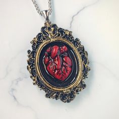 🖤 Embrace your dark elegance with my Handcrafted Realistic Heart Cameo Pendant Necklace 🖤 Indulge your Gothic sensibilities with this strikingly lifelike anatomical heart pendant, meticulously crafted by hand from rich, blood-red epoxy resin. This design features a cameo style vintage picture frame in golden color. ✨ Product Details: * Material: Each pendant is carefully handcrafted from high-quality epoxy resin, capturing the essence of a real heart with its intricate details and deep, captiv Anatomical Heart Pendant, Realistic Heart, Anatomical Heart Necklace, Real Heart, Dark Elegance, Cameo Pendant Necklace, Anatomical Heart, Vintage Picture Frames, Vintage Cameo