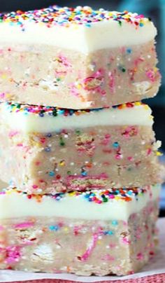 three pieces of cake with sprinkles stacked on top of each other