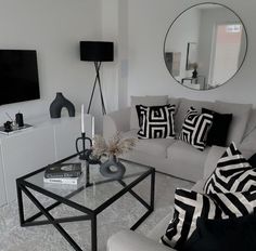 a living room filled with furniture and a flat screen tv mounted to the side of a wall