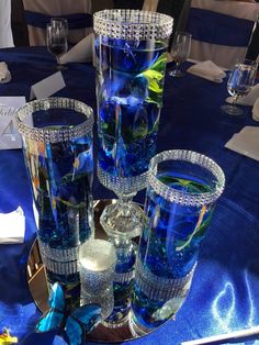 blue glass vases and glasses on a table