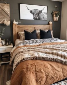 a bedroom with a bed, nightstands and pictures hanging on the wall above it