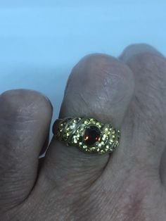 Golden Topaz and garnet gold finished 925 Sterling Filigree Setting Handmade Size 6.5 can be resized, my jeweler charges $10-$20 All rings are shipped free in the US in a nice gift box. Check out our over a THOUSAND great reviews Engraving is $4 per letter and is not always perfect depending on the piece. It can take a few days if the jeweler is busy. This is payable to Paypal Judithsltd@gmail.com Gothic Ring, Garnet And Gold, Bronze Ring, Gothic Rings, Stone Inlay, Sterling Jewelry, Red Band, Mothersday Gifts, Rings Cool