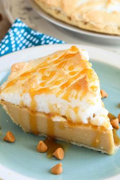 a slice of cheesecake on a plate with nuts around the edge and another pie in the background