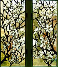 two stained glass windows with white flowers on them