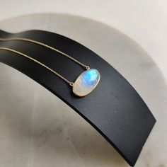 "ITEM DESCRIPTION: This stunning necklace is set in 14k Solid Yellow Gold with Natural Rainbow Moonstone with utmost precision. It is an unique gemstone necklace for nearly every occasion and is completely hassle-free jewelry. ITEM DETAILS: * Gem: Rainbow Moonstone * Gem Size: 10x20mm * Gem Shape: Oval * Gem Weight: 12.54 carats * Gold Purity: 14KT * Gold Weight: 1.29 gram * Total Weight: 3.79 gram * necklace Length: 16\" Inches gold chain. The Gold purity is guaranteed and it comes with authent Oval Moonstone Necklace In Yellow Gold, Handmade Jewelry Box, Rainbow Moonstone Pendant, Blue Moonstone, Bezel Pendant, June Birthstone, Natural Rainbow, Moonstone Pendant, Yellow Gold Pendants