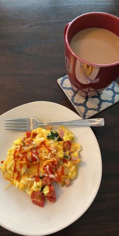 an omelet on a plate next to a cup of coffee