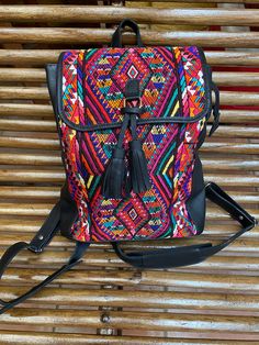 Black leather and handmade huipil weaved on a backstrap loom , decorated with tassels that add movement to this practical city backpack. it takes more than three months to complete and is a unique piece that will add color and style to any wardrobe , A huipil is a women's blouse worn by Mayan women from Guatemala. Each handmade Huipil its unique since it depends on the inspiration of the weaver A comfortable yet unique piece easy to match with any wardrobe because of the rich combination of colo Mayan Women, Cute Backpack, Backstrap Loom, City Backpack, The Weaver, Cute Backpacks, Vera Bradley Backpack, Backpack Purse, Black Backpack