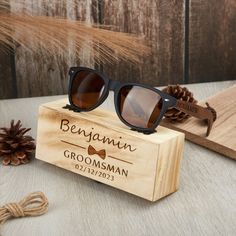 the wooden sunglasses are on display next to some pine cones and a pair of brown glasses