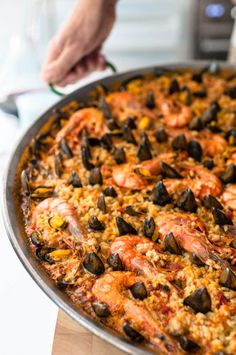 a large pizza with shrimp and mussels on it