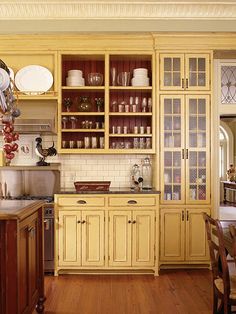 a kitchen filled with lots of wooden cabinets