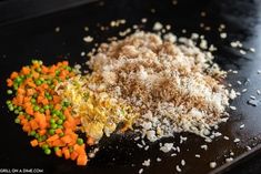 there are several different types of food on the counter top, including rice and carrots