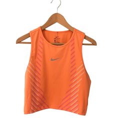 Womens Nike Crop Top Tank Size Large Orange With Pink And White Lines New With Tags 80% Polyester 20% Spandex Nike Logo On Front Is Reflective Sleeveless Orange Activewear For Summer, Orange Athleisure Tops For Sports, Orange Sleeveless Top For Athleisure, Orange Sleeveless Athleisure Top, Fitted Sleeveless Orange Activewear, Orange Stretch Sports Tops, Orange Sleeveless Workout Tops, Fitted Orange Gym Tops, Orange Sleeveless Top For Workout