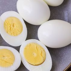 four hard boiled eggs sitting on top of a plate