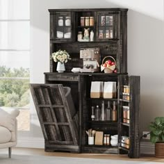 a living room with an open bookcase next to a couch