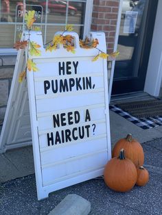 a sign that says hey pumpkin need a haircut? next to two small pumpkins