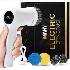 the electric hair dryer is being held by someone's hand with other items around it