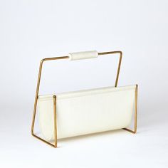 a white purse with gold metal handles on a white background, the bag is empty and ready for someone to put it in