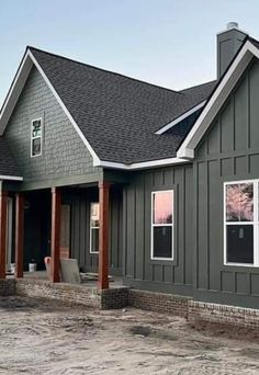 a gray house with white trim and windows