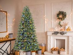 a decorated christmas tree sitting next to a fireplace