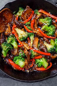 stir fry with broccoli and red peppers in a wok